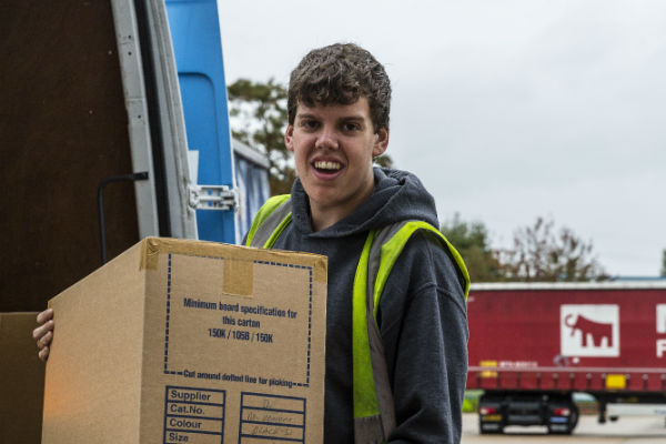 Goods in: a James and James team member unloads a box from a truck, as part of the order fulfillment process