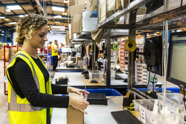 A James and James team member packs an item in a box, as part of the order fulfilment process