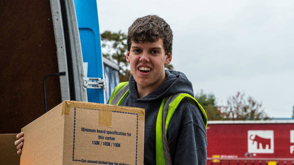 A James and James team member unloads a box from a van, as part of the order fulfilment process