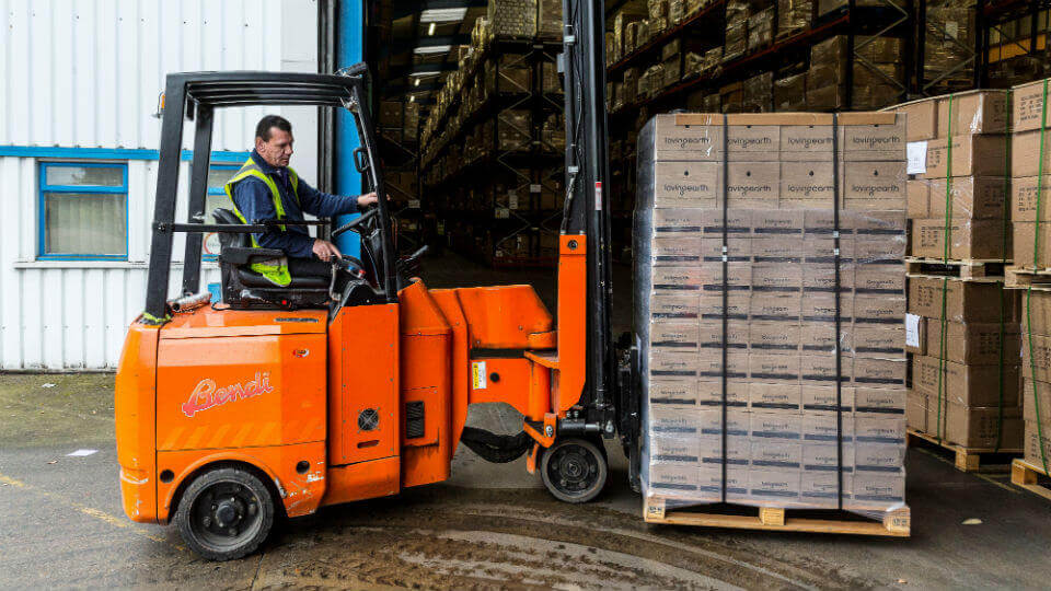 A forklift moves a pallet of stock into a James and James fulfilment centre