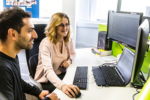 A client is shown the fulfilment process on a laptop