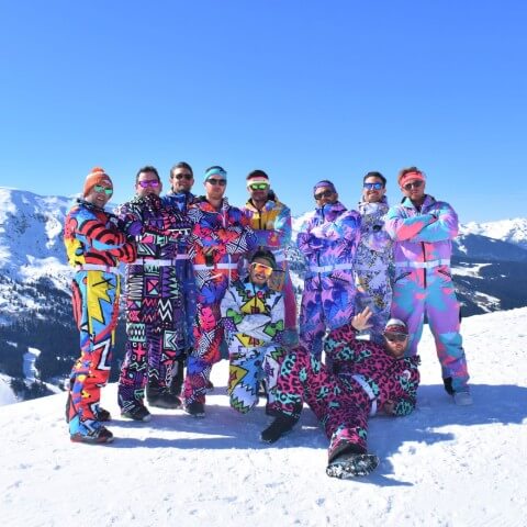 A group of people wearing OOSC skisuits, fulfilled by James and James