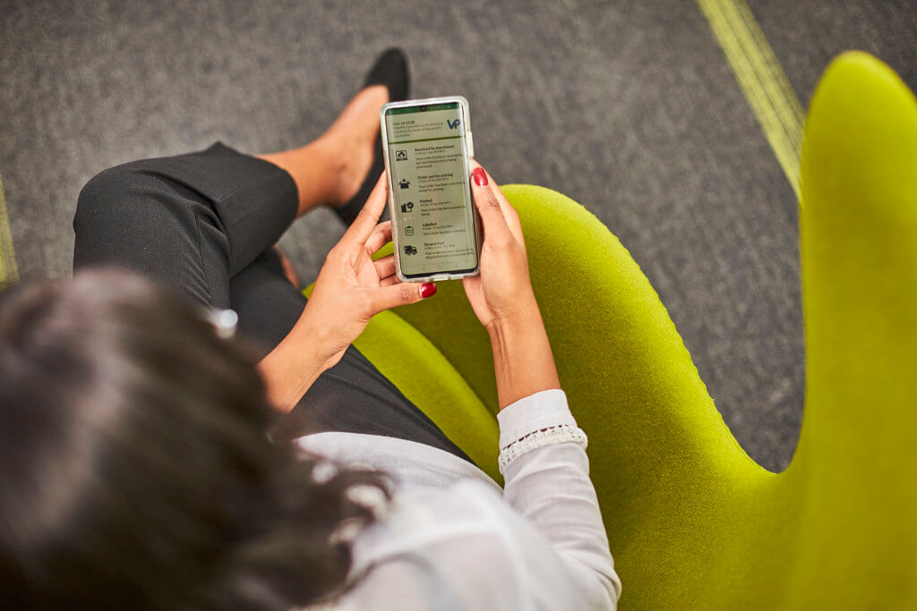 Luxury product fulfillment 5 A woman sitting on a chair using an app on her mobile phone