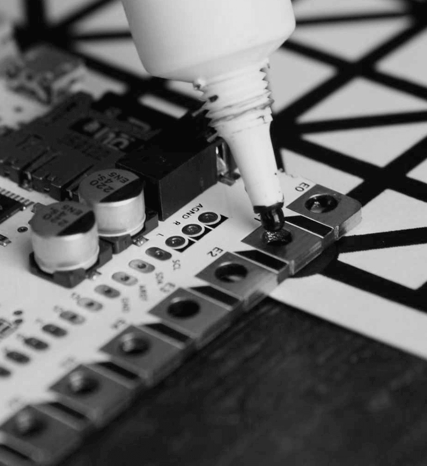 Conductive paint being applied to a circuit board