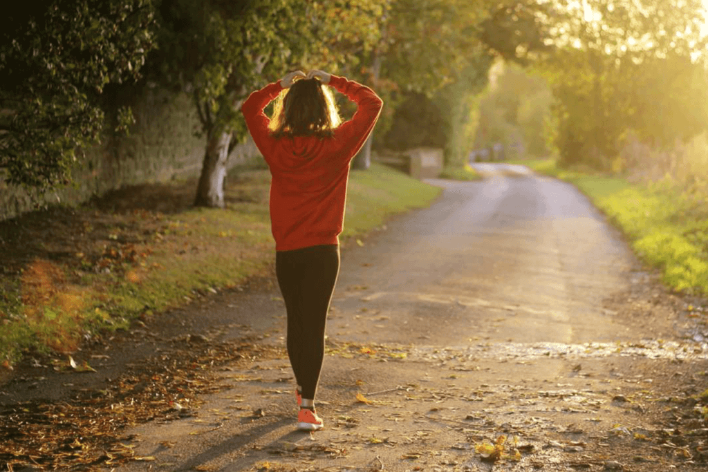 Runner preparing to run down sunlit road