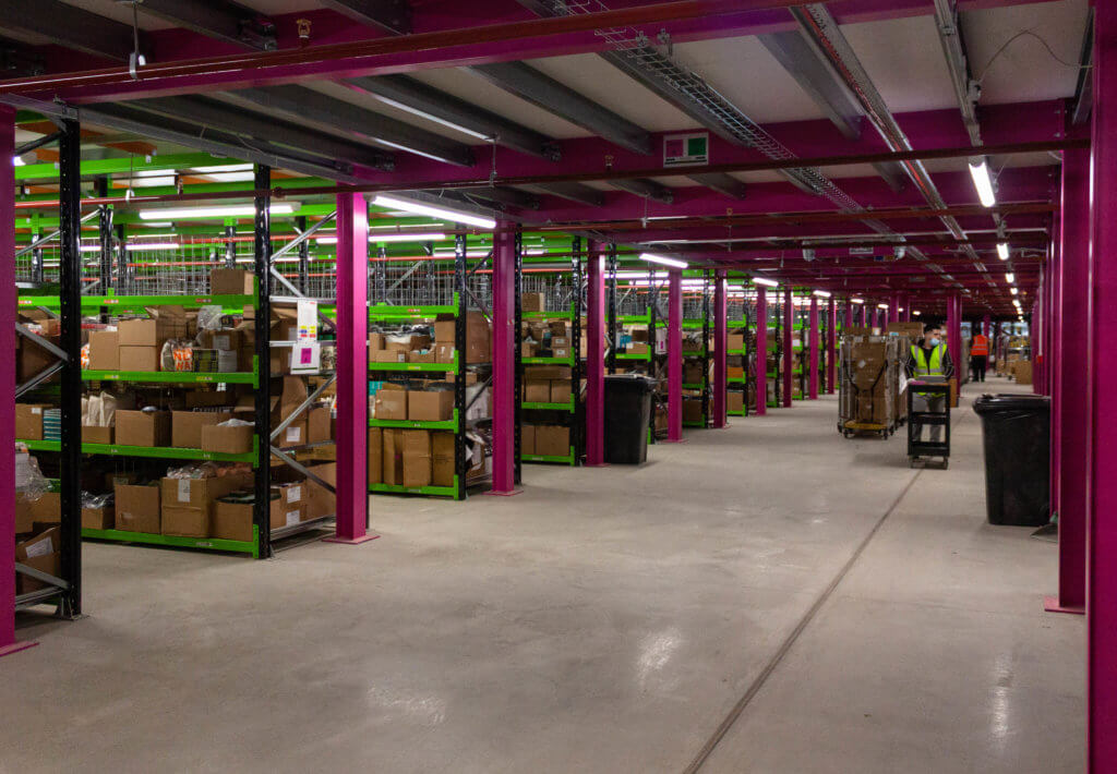 European fulfillment center 2 Ground floor of Liberty pick tower with pink and green racking