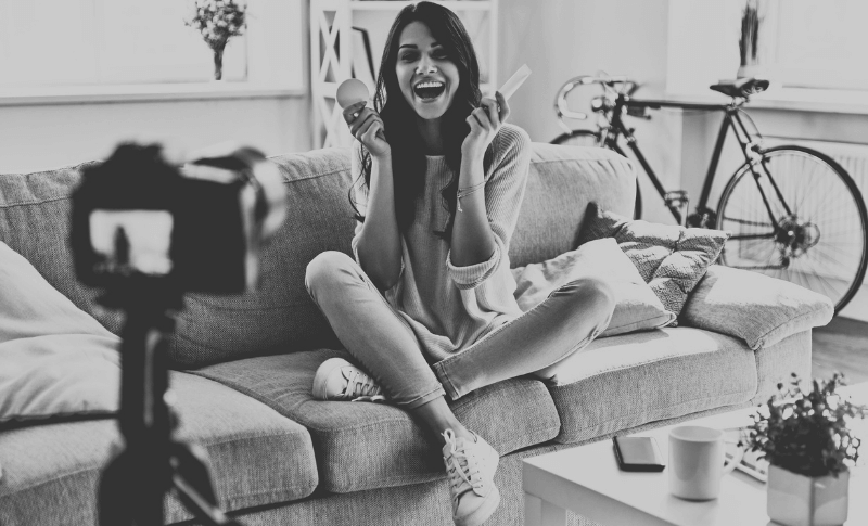 A photograph of a girl in front of a video camera